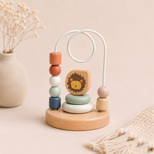 Bead maze Wooden baby toy with colorful beads and a lion figure on a beige background