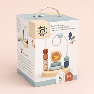 Bead Maze Wooden toy with lion design on a Speedy Monkey packaging box against a light pink background