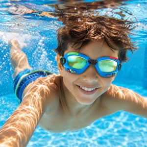 Child swimming underwater wearing Bling2o Gamer Console Cobalt swim goggles in a clear blue pool