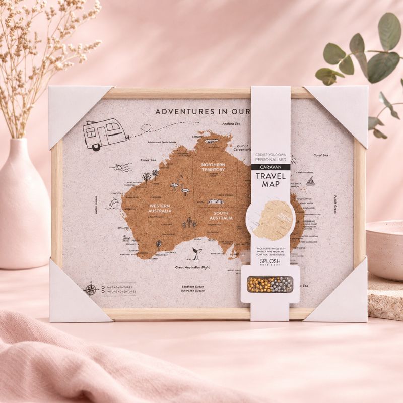 Travel map of Australia with packaging on a pink surface