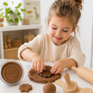 Smiling child playing with Chocolate Brown Playdough during creative sensory play