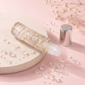 Clarity essential oil roller Skincare bottle with pearls on a pink background