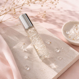 Clarity essential oil roller with silver cap with dried flowers and a bowl in the background