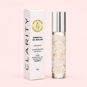 Clarity Essential oil roller with packaging on a pink background