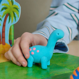 Close-up of child shaping dinosaur clay toy hands-on activity