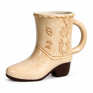 Tan ceramic cowboy boot mug with embossed Western floral design