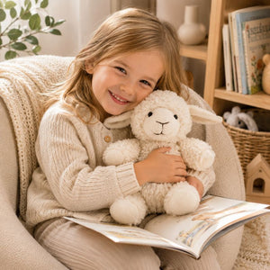 Child cuddling white curly sheep soft toy while reading in a cosy nursery setting by Love Shack Giftware