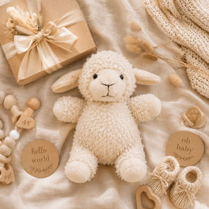 White curly sheep soft toy styled with baby shower gifts, linen blanket and nursery accessories by Love Shack Giftware