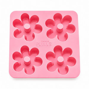 A Drinks Plinks - Retro Daisy Pink Ice Cube Tray featuring the brand name 'PLINKS' embossed in the center, shown on a clean white background.
