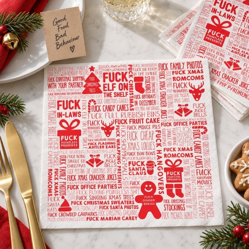 F#ck Christmas paper napkins styled with Christmas decorations and gold cutlery