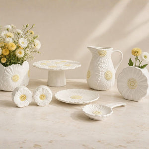 White ceramic tableware set with floral designs on a beige background