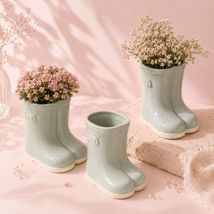 Sage gumboots with flowers on a pink background