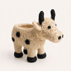 Side view of jersey cow planter on minimal background
