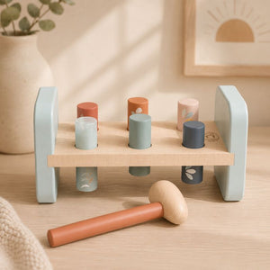 Hammer bench Wooden toy set with colorful cylindrical blocks and a hammer on a wooden surface. - Loveshack Giftware