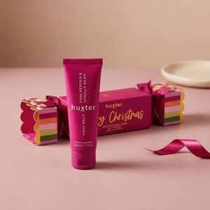 Huxter Hand Balm Bon Bon and 50ml hand balm on a soft blush pink surface