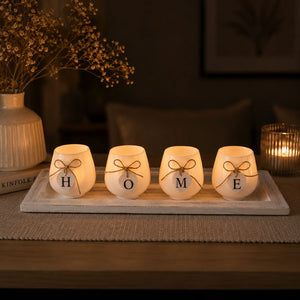 Decorative HOME candle holder tray with lit candles styled on a console table with elegant lighting and cozy home accents.