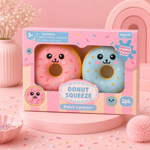 Packaged donut-shaped toys with a pink background