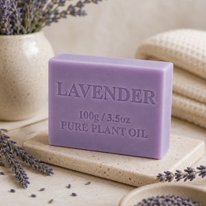 Lavender Soap Bar 100g on a stone surface with lavender flowers around