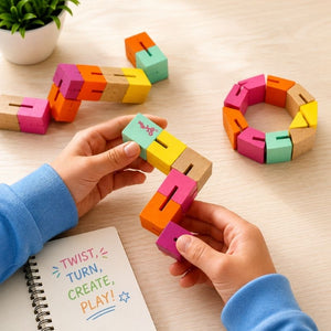 Majigg Twisty Blocks wooden fidget toy pieces being assembled on a light surface with a plant and notebook in the background.