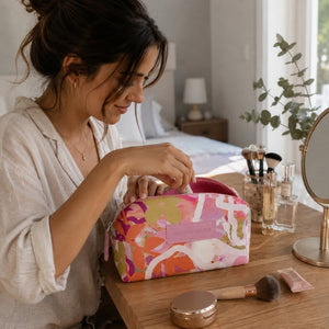 Mindful Marlo Ivy makeup bag with beauty essentials on a wooden vanity
