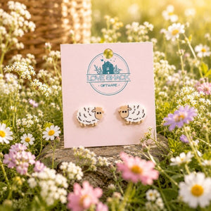 Mini Sheep Stud Earrings on a pink card with 'Love Shack Giftware' logo in a field of flowers.