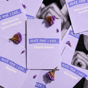 Never Have I Ever lavender cards styled in an aesthetic flat lay with dried flowers