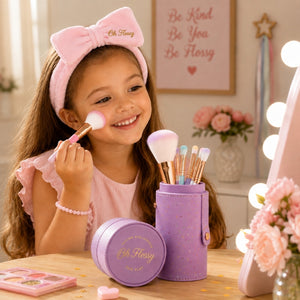 Child using Oh Flossy rainbow makeup brushes with pastel makeup storage case