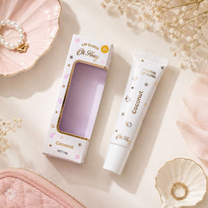 Oh Flossy Coconut Lip Gloss and packaging with pastel accessories