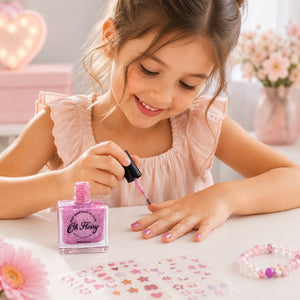 Child painting nails with Oh Flossy Pink Glitter Kids Nail Polish