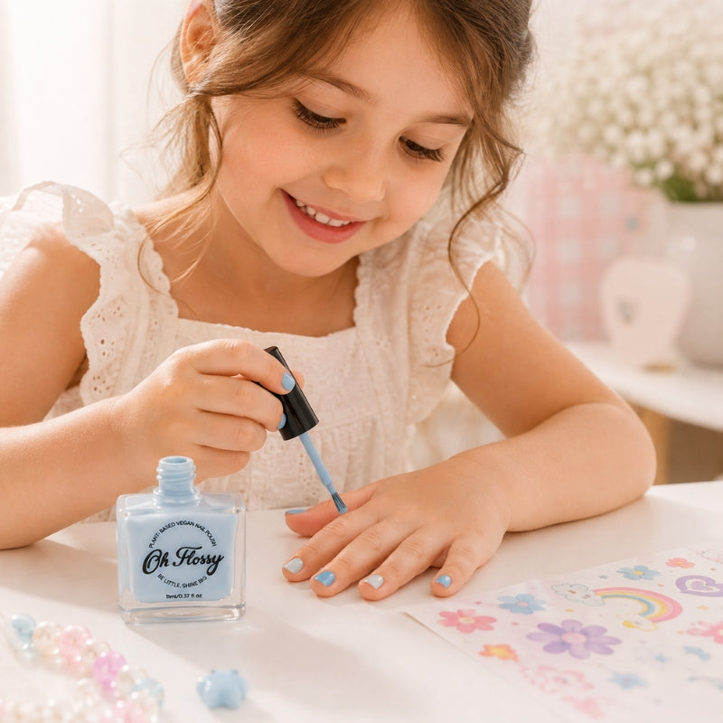 Child applying Oh Flossy Cream Blue Kids Nail Polish