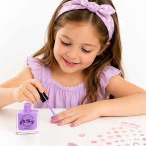 Child using Oh Flossy purple kids nail polish during creative play