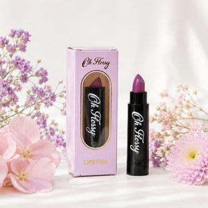 Oh Flossy Purple Natural Lipstick for Kids displayed with pink packaging and pastel flowers