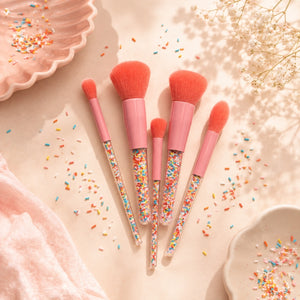 Oh Flossy five-piece Sprinkle Makeup Brush Set arranged with colorful sprinkles