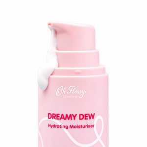 Close-up of Oh Flossy Dreamy Dew Moisturiser pink pump dispenser with white cream against a clean background.