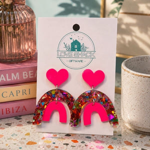 Pop Rainbow Dangle Earrings on a 'Love Shack Giftware' card with books and a mug in the background.
