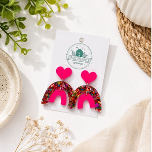 Pop Rainbow Dangle Earrings on a card with 'Love Shack' branding, surrounded by decorative elements.