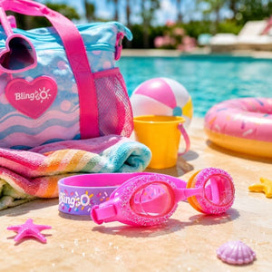 Rock Candy Pink Swim Goggles styled with a children's swim bag, colorful beach toys, and pool accessories, capturing a fun family-friendly summer adventure theme.