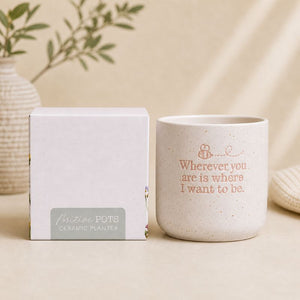 Ceramic quote planter with gift box packaging on beige background