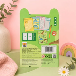 Green packaging of Tiger Tribe with dinosaur-themed activities on a pink background