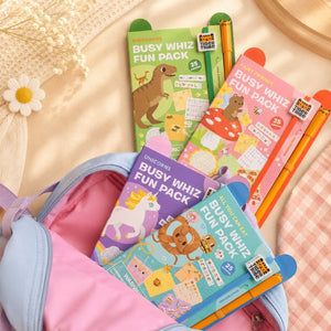 Busy Whiz Fun Pack books with colorful covers on a pink surface.