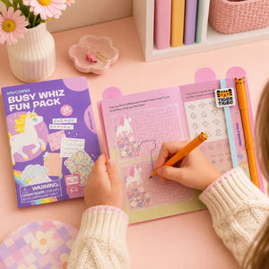 Child coloring in a 'Busy Whiz Fun Pack' with a pink desk and stationery items. - Loveshack Giftware