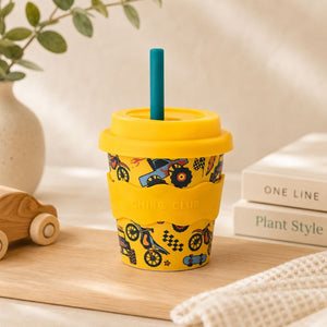 Wheelies Babychino Cup (4 oz) and blue straw on a wooden surface.