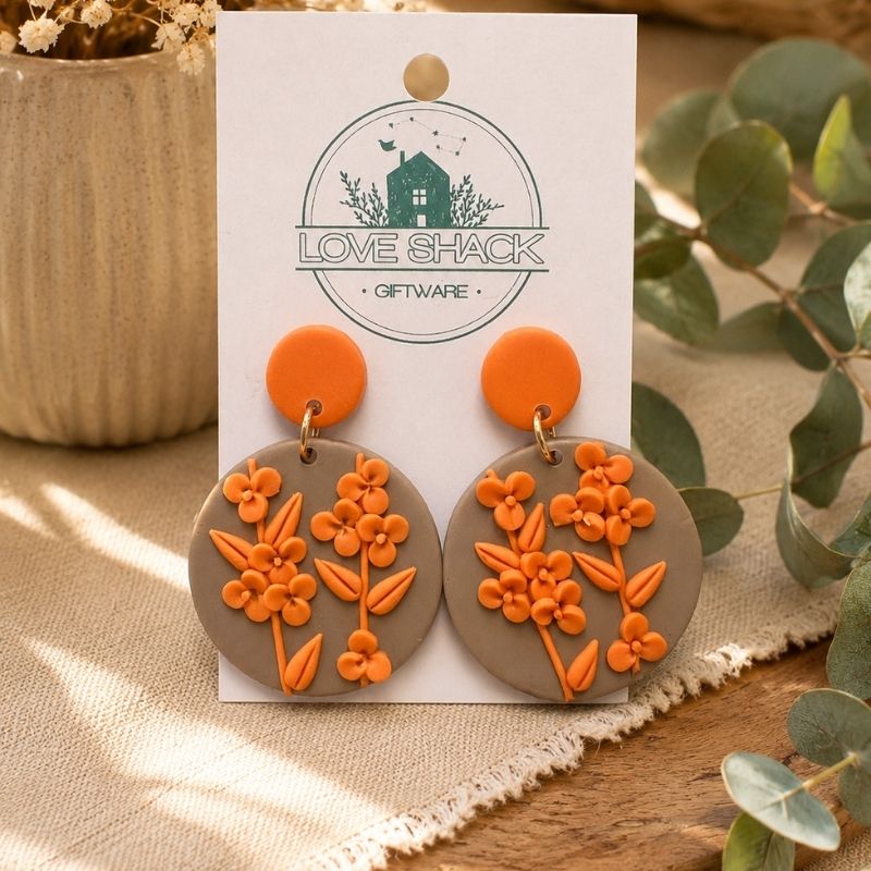 Autumn Bloom Flower Dangle Earrings on a 'Love Shack Giftware' card with plants in the background