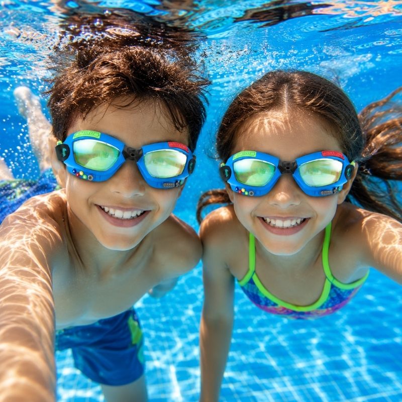 Boy and girl swimming underwater wearing Bling2o Gamer Console Cobalt swim goggles in a swimming pool
