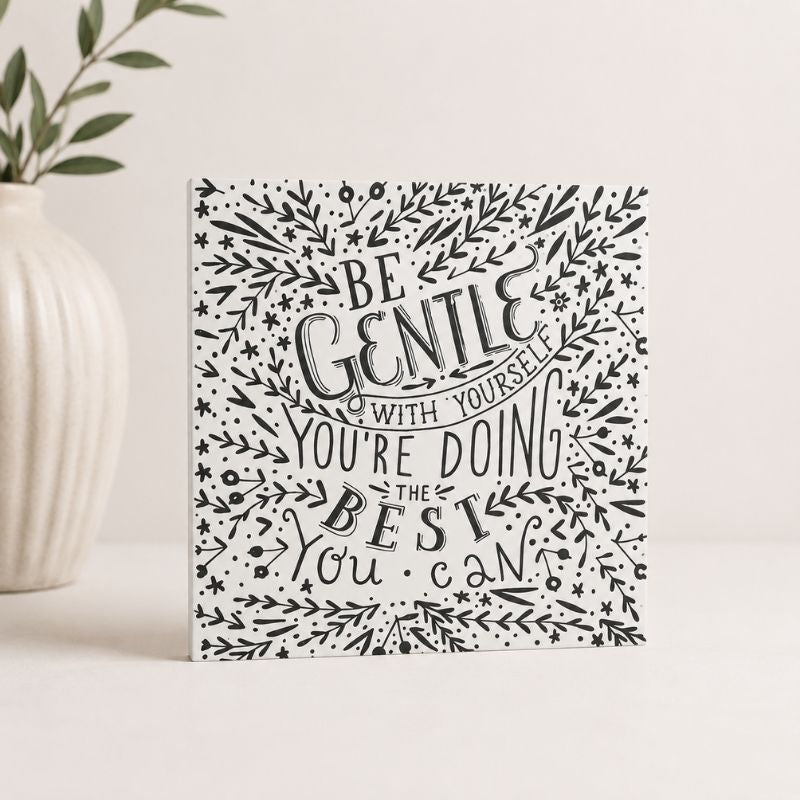 Wooden quote Plaque with text 'Be gentle with yourself, you're doing the best you can' on a floral wreath design.
