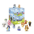 Collection of Bluey toy figures with their packaging on a white background