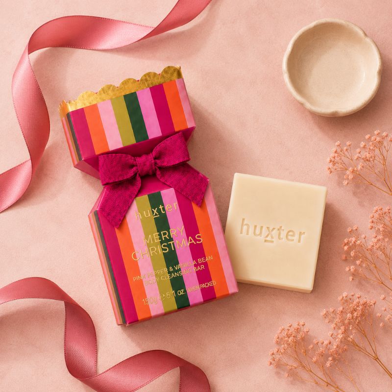Huxter Pink Pepper & Vanilla Bean cleansing bar and colourful Christmas gift box flat lay