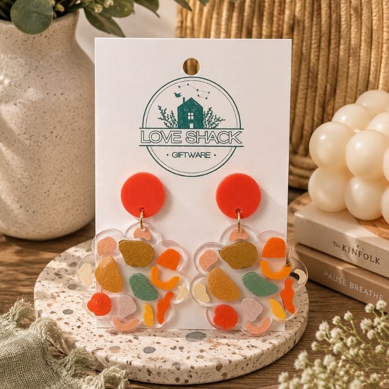 Handmade Boho Dangle Earrings featuring colorful abstract polymer clay designs with vibrant orange accents by Love Shack Giftware.