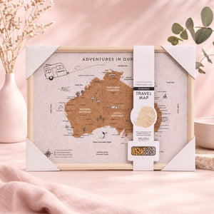 Travel map of Australia with packaging on a pink surface