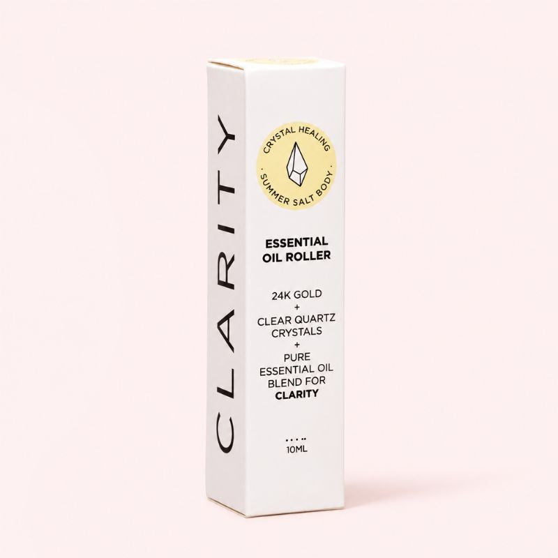 Essential oil roller packaging with 'Clarity' branding on a light pink background
